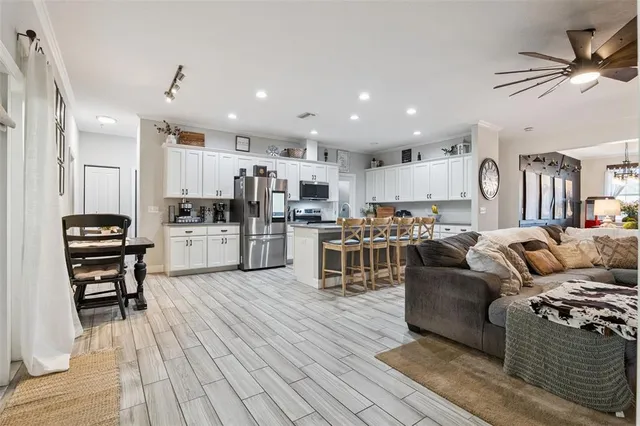 a living room with furniture and kitchen view