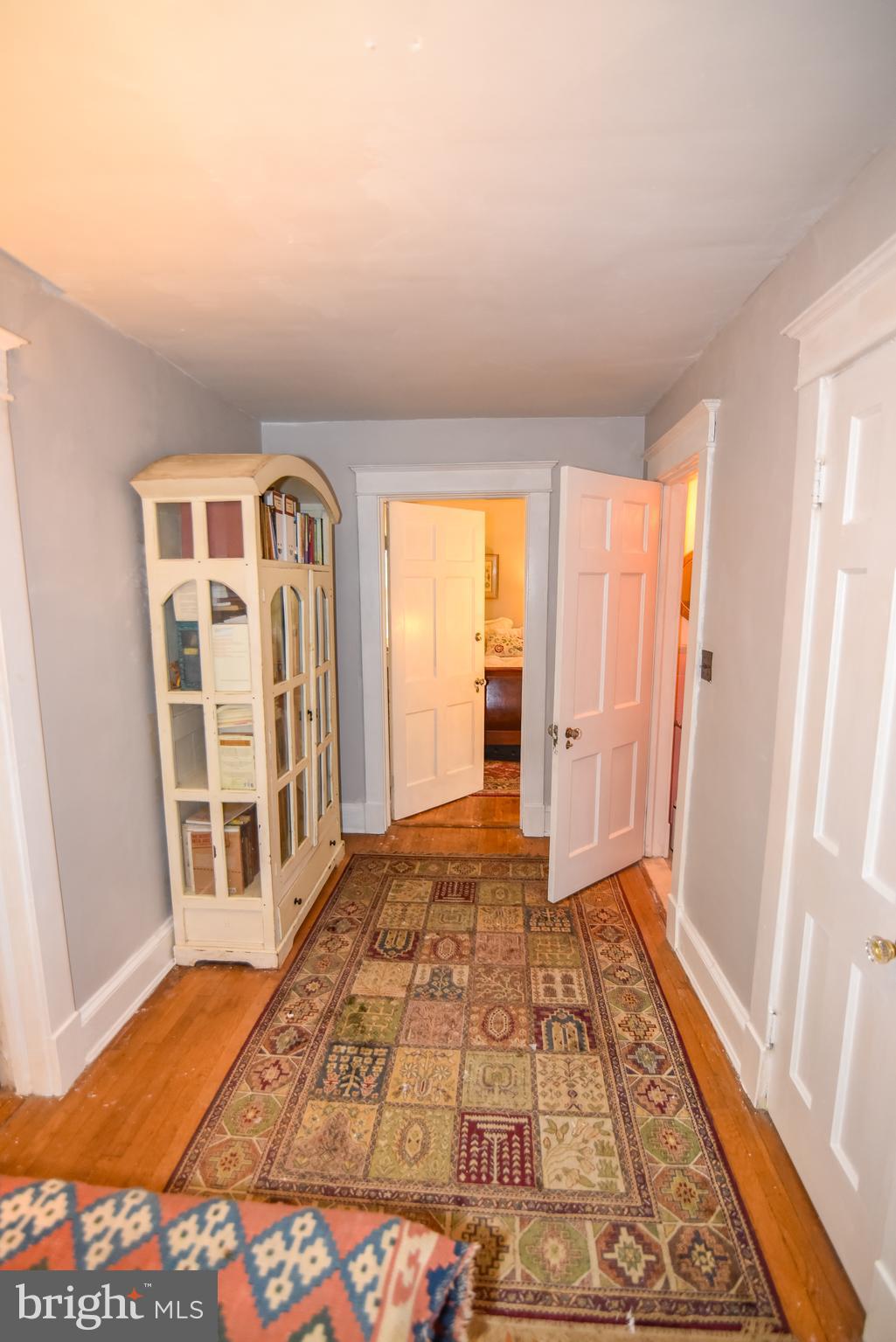24 Merrymount Road Baltimore, MD 21210 - Photo 22 of 48 a view of a bedroom with wooden floor and windows