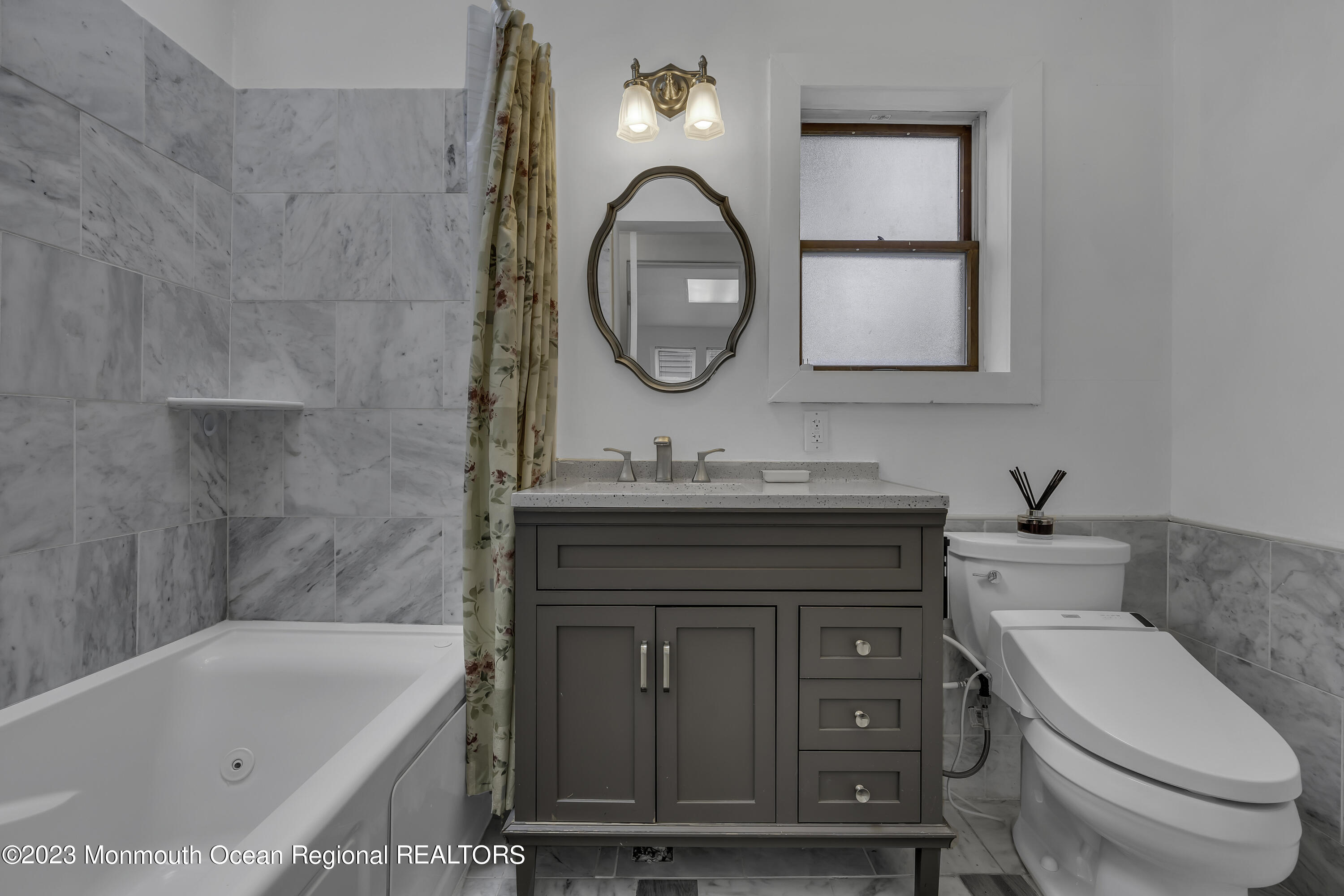 237 Broadway Union Beach, NJ 07735 - Photo 13 of 23 a bathroom with a granite countertop toilet a sink and a bathtub
