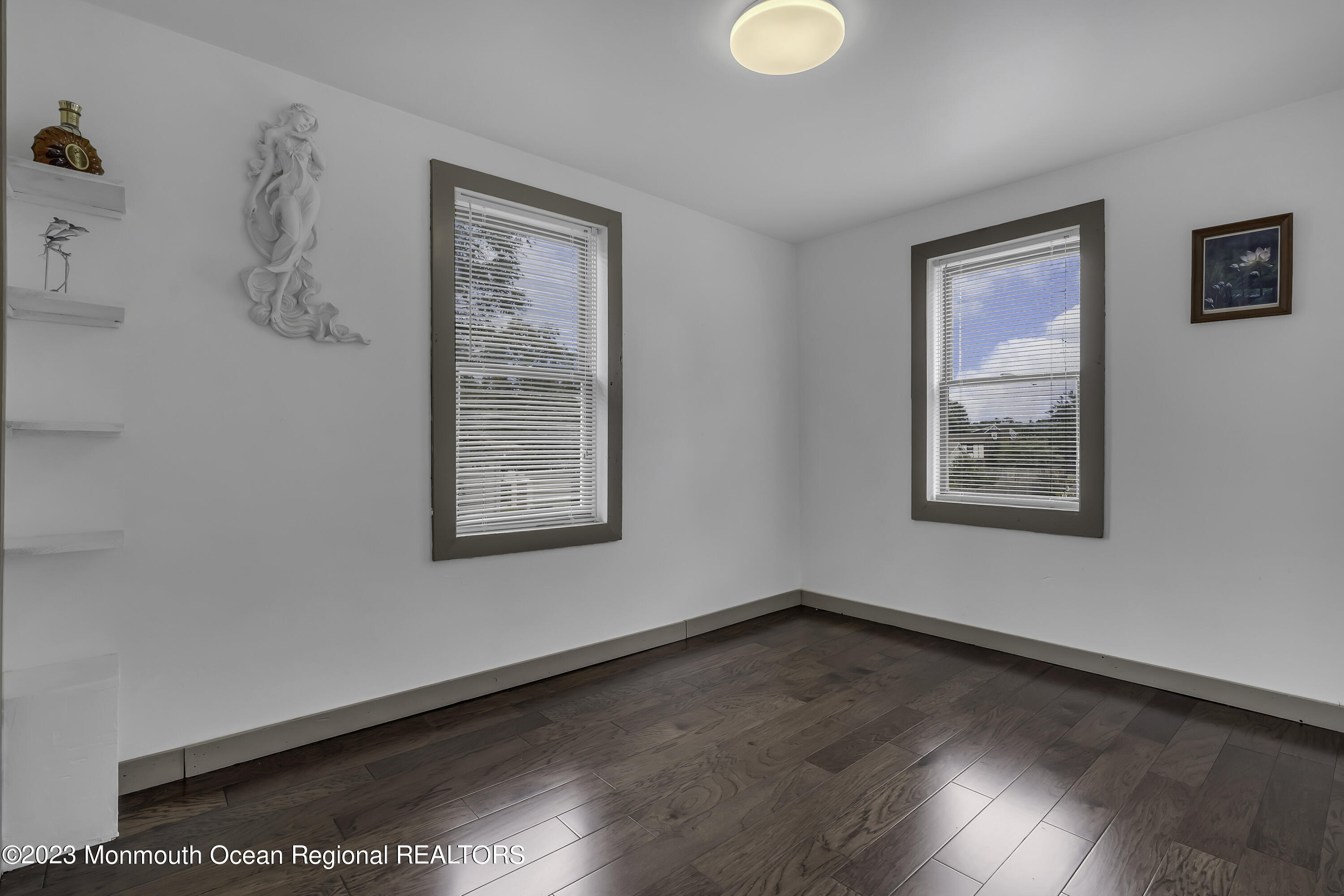 237 Broadway Union Beach, NJ 07735 - Photo 17 of 23 a view of an empty room with wooden floor and a window