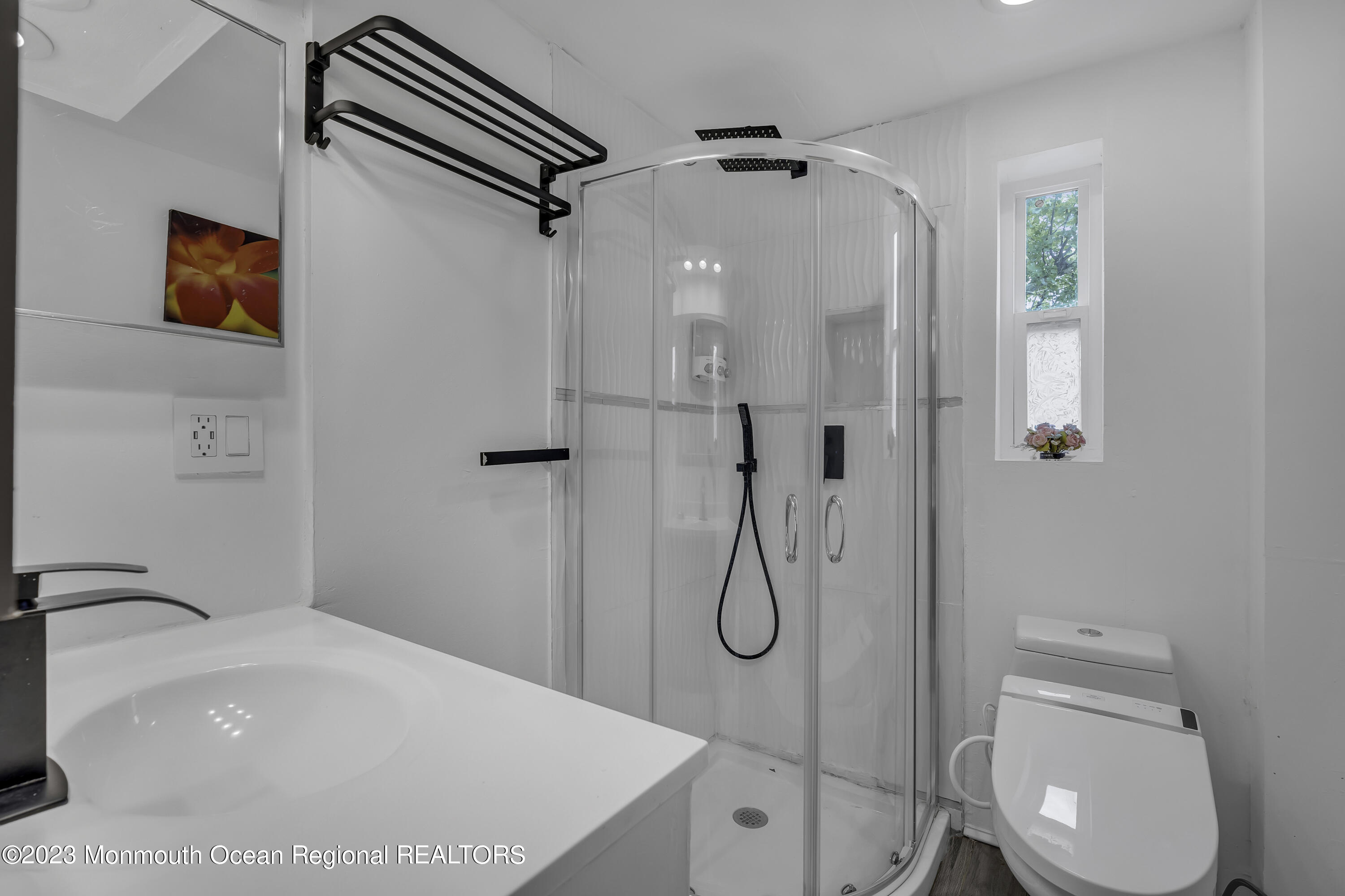 237 Broadway Union Beach, NJ 07735 - Photo 19 of 23 a bathroom with a sink a toilet and shower