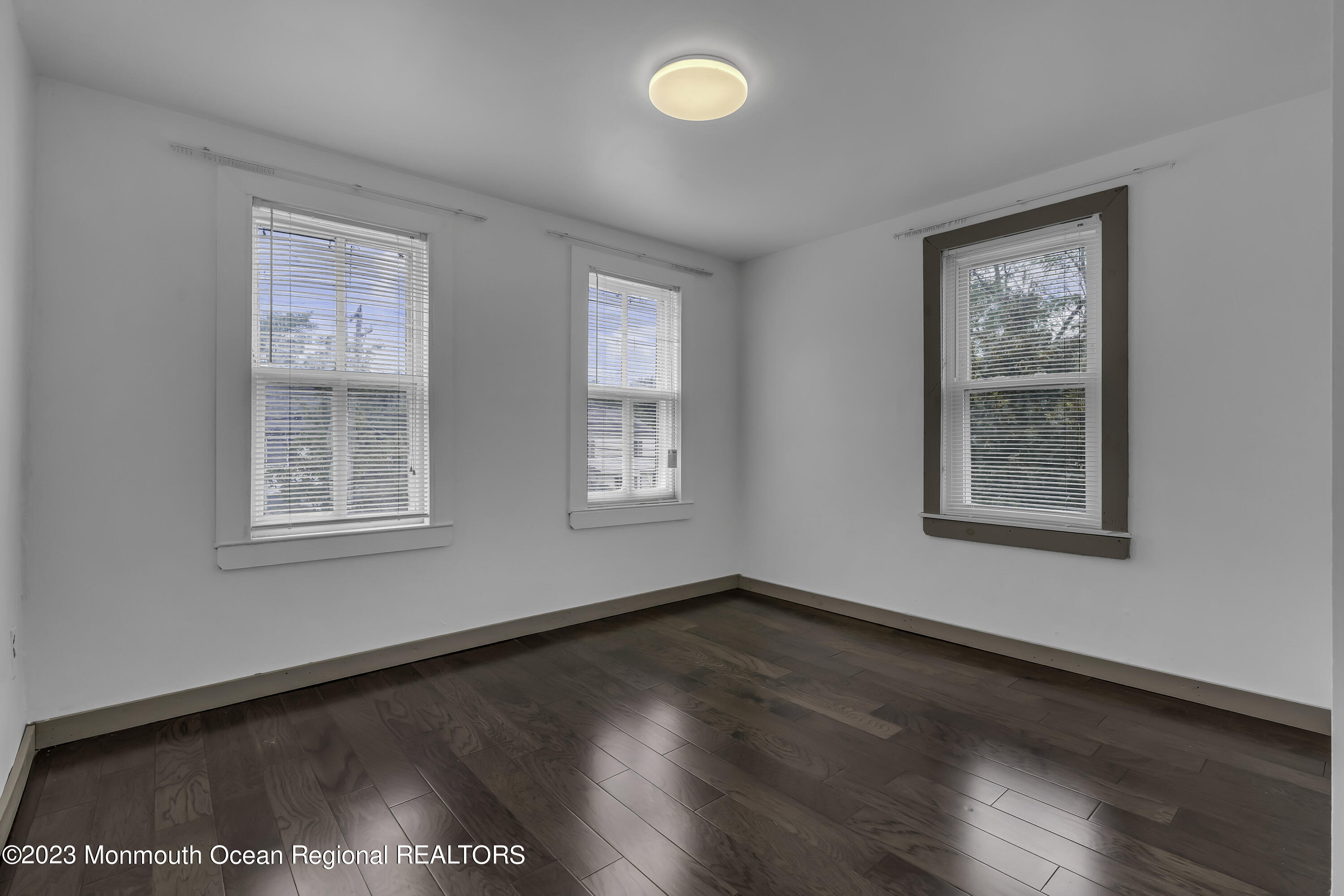 237 Broadway Union Beach, NJ 07735 - Photo 20 of 23 a view of an empty room with wooden floor and a window
