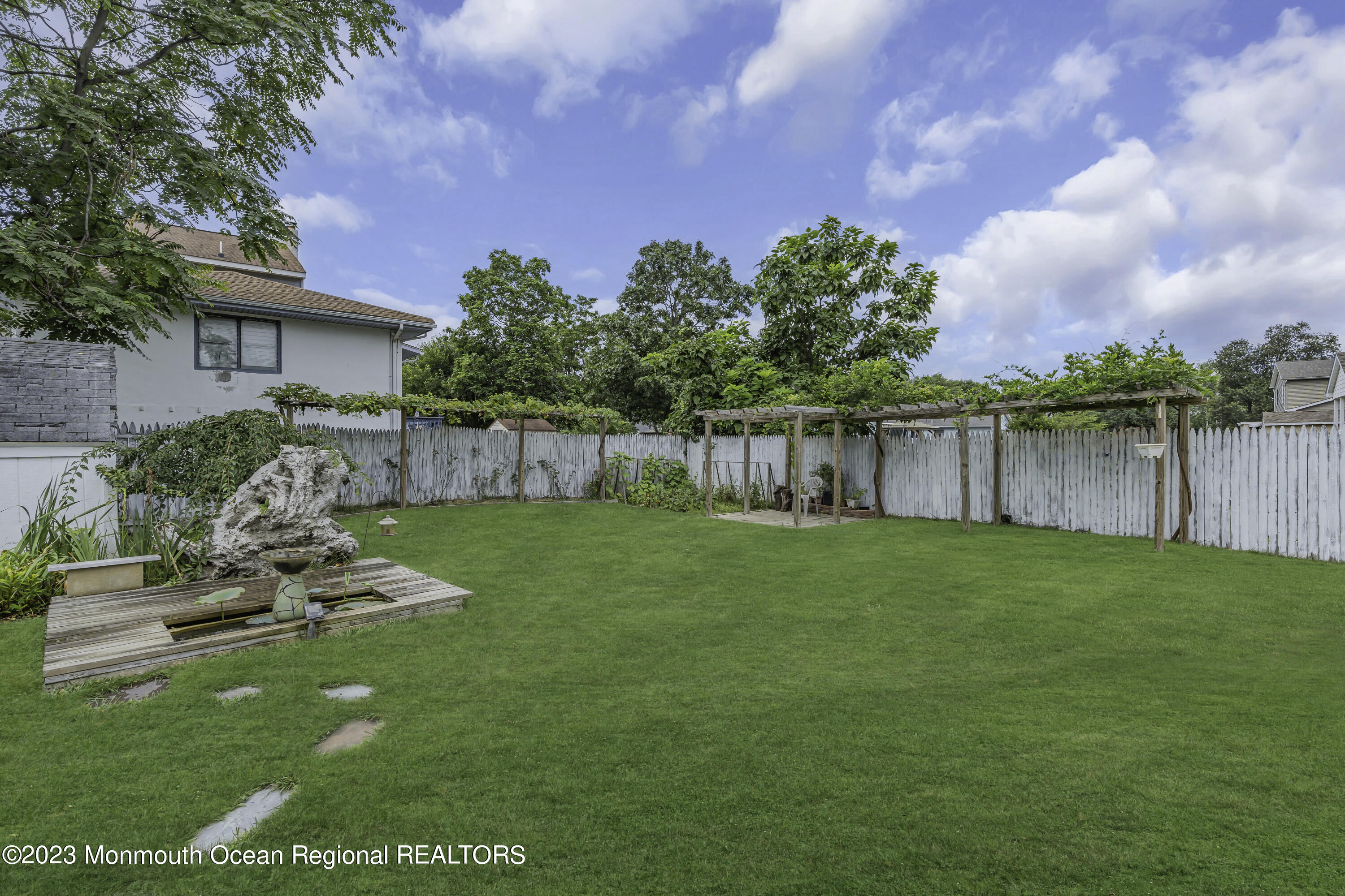 237 Broadway Union Beach, NJ 07735 - Photo 22 of 23 a view of a backyard with sitting area