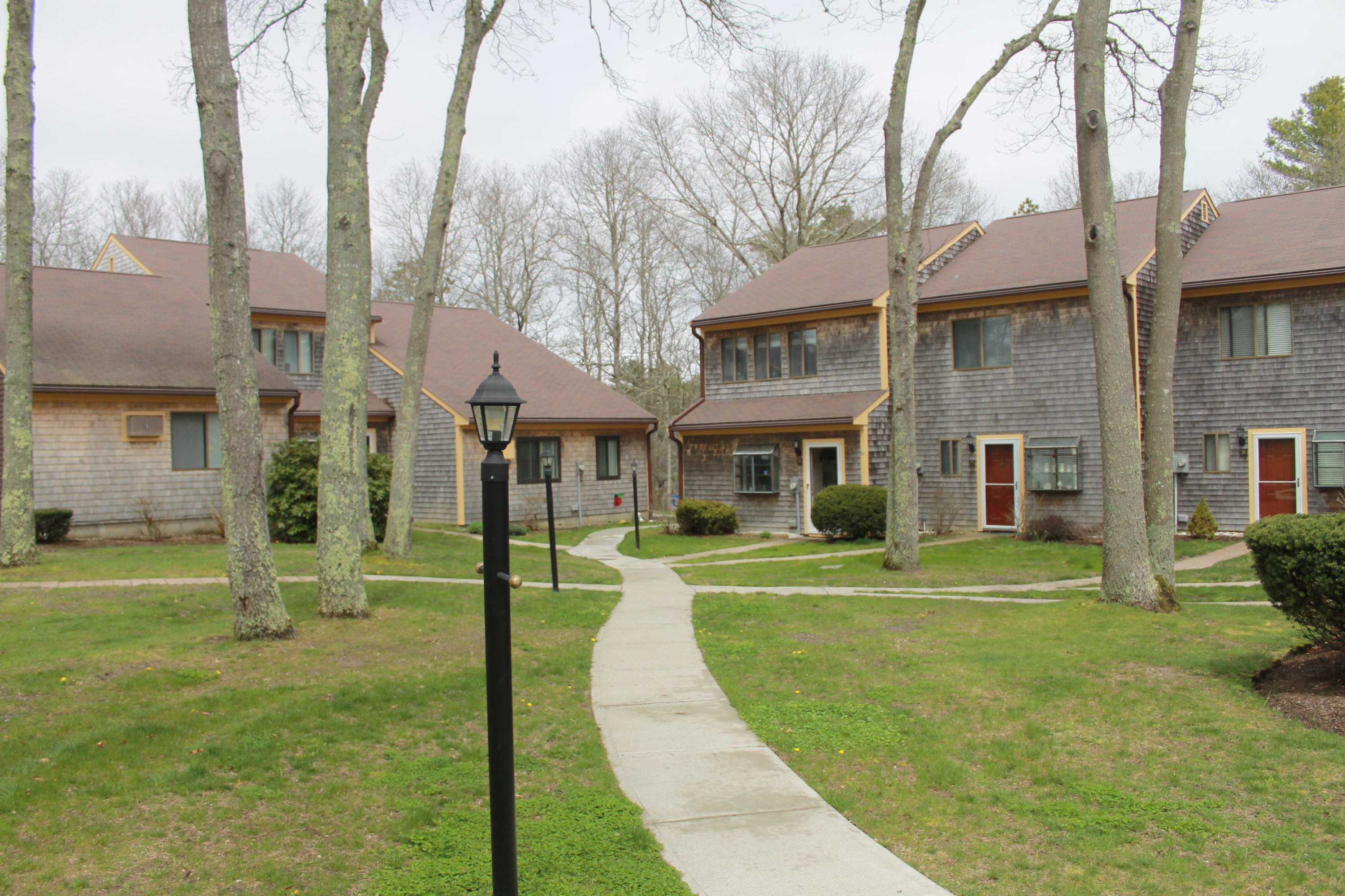 26 Round House Road, Unit 26 Bourne, MA 02532 - Photo 1 of 25 a front view of a house with a yard