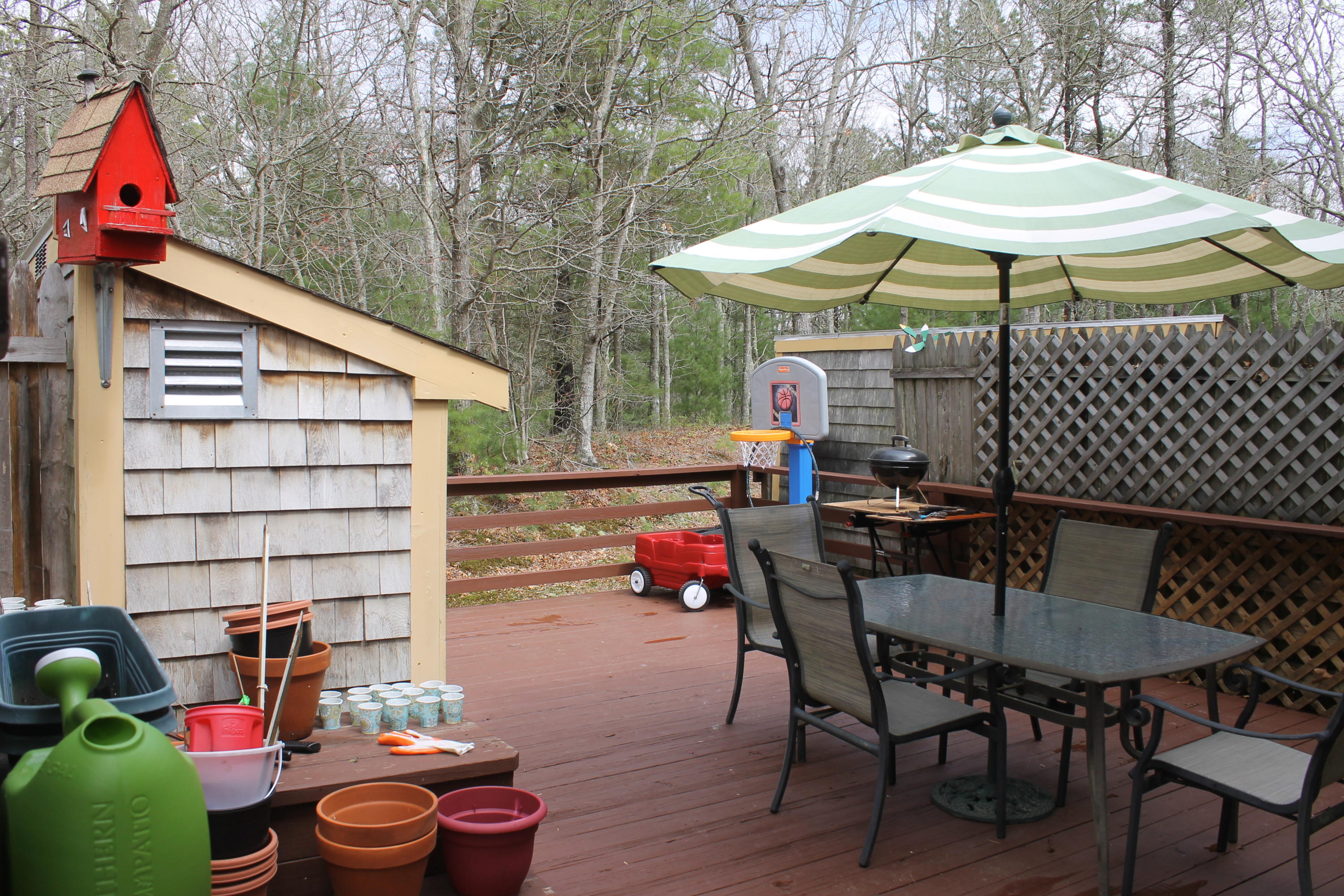 26 Round House Road, Unit 26 Bourne, MA 02532 - Photo 19 of 25 a view of a patio with a table and chairs under an umbrella