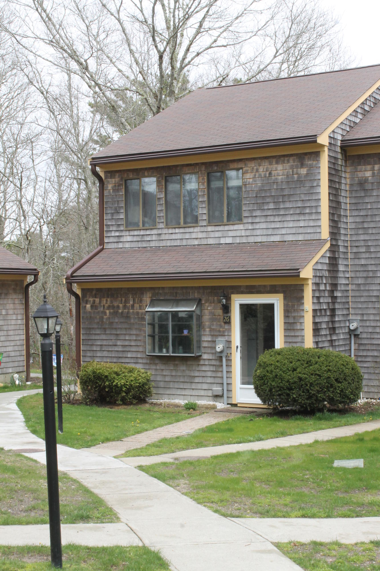 26 Round House Road, Unit 26 Bourne, MA 02532 - Photo 2 of 25 a front view of a house with garden