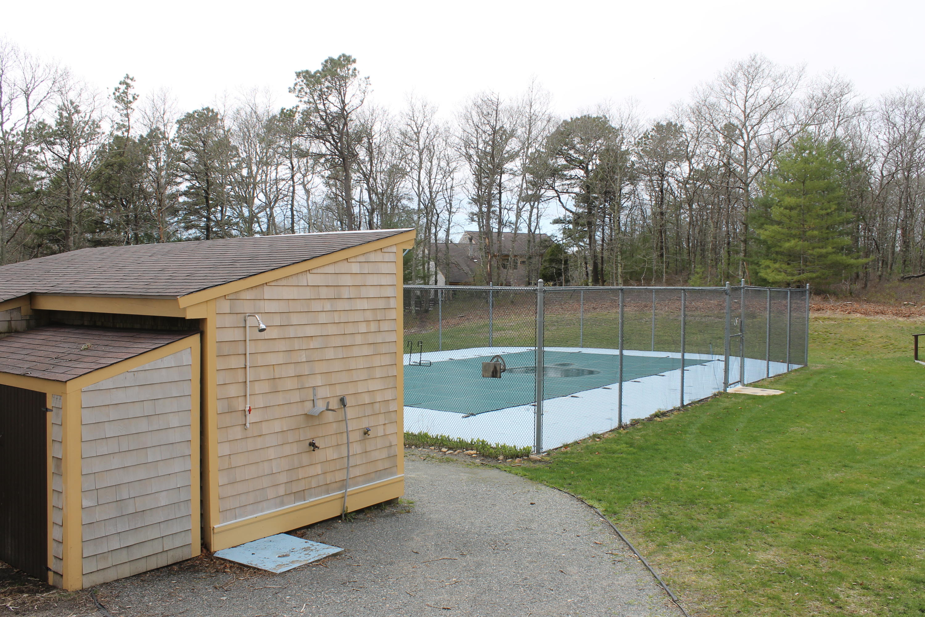 26 Round House Road, Unit 26 Bourne, MA 02532 - Photo 21 of 25 a view of a backyard with a cabin