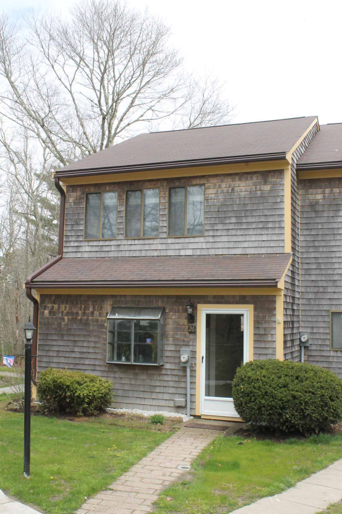 26 Round House Road, Unit 26 Bourne, MA 02532 - Photo 22 of 25 a front view of a house with a yard