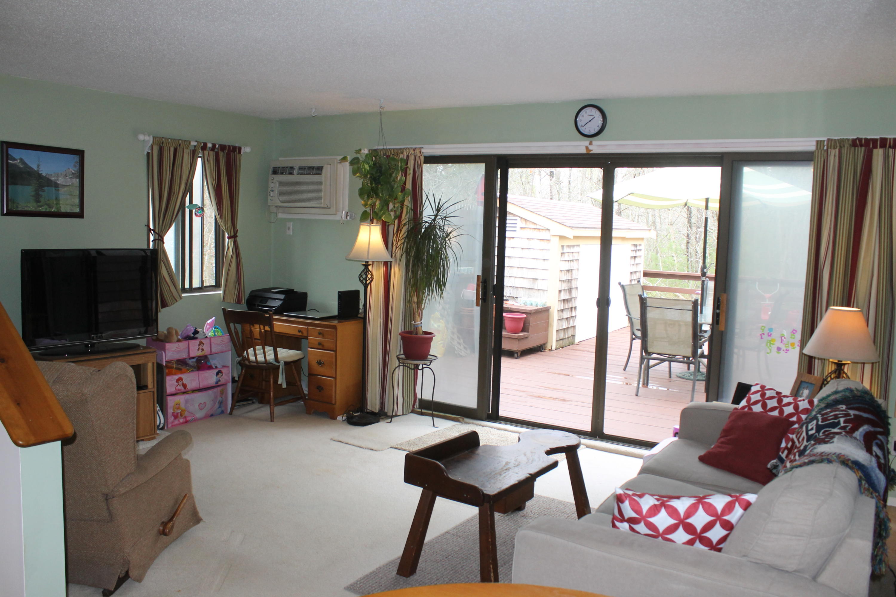 26 Round House Road, Unit 26 Bourne, MA 02532 - Photo 3 of 25 a living room with furniture and a flat screen tv