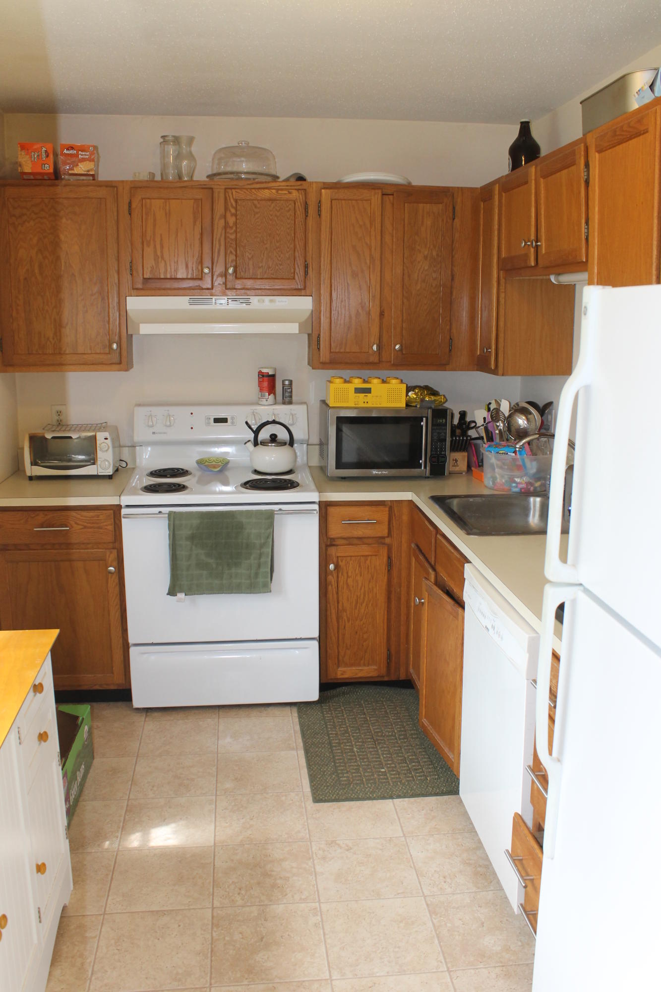 26 Round House Road, Unit 26 Bourne, MA 02532 - Photo 7 of 25 a kitchen with a sink a stove and cabinets