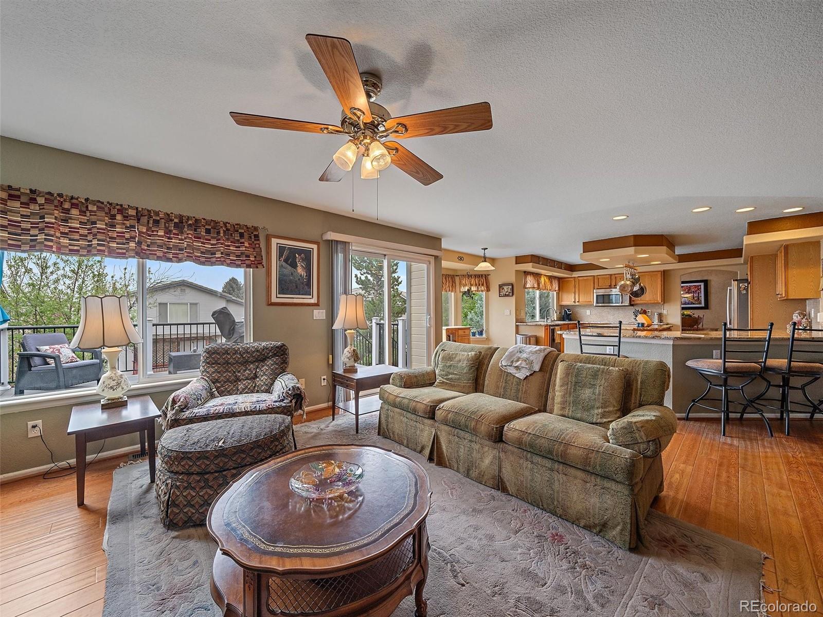 6523 Shannon Trail Highlands Ranch, CO 80130 - Photo 12 of 38 a living room with furniture and a wooden floor