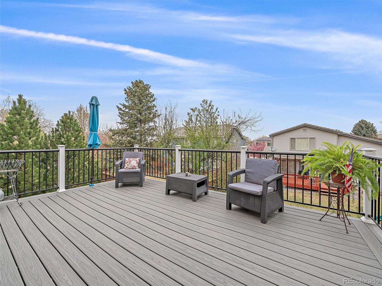 6523 Shannon Trail Highlands Ranch, CO 80130 - Photo 13 of 38 a view of a roof deck with wooden floor and outdoor seating