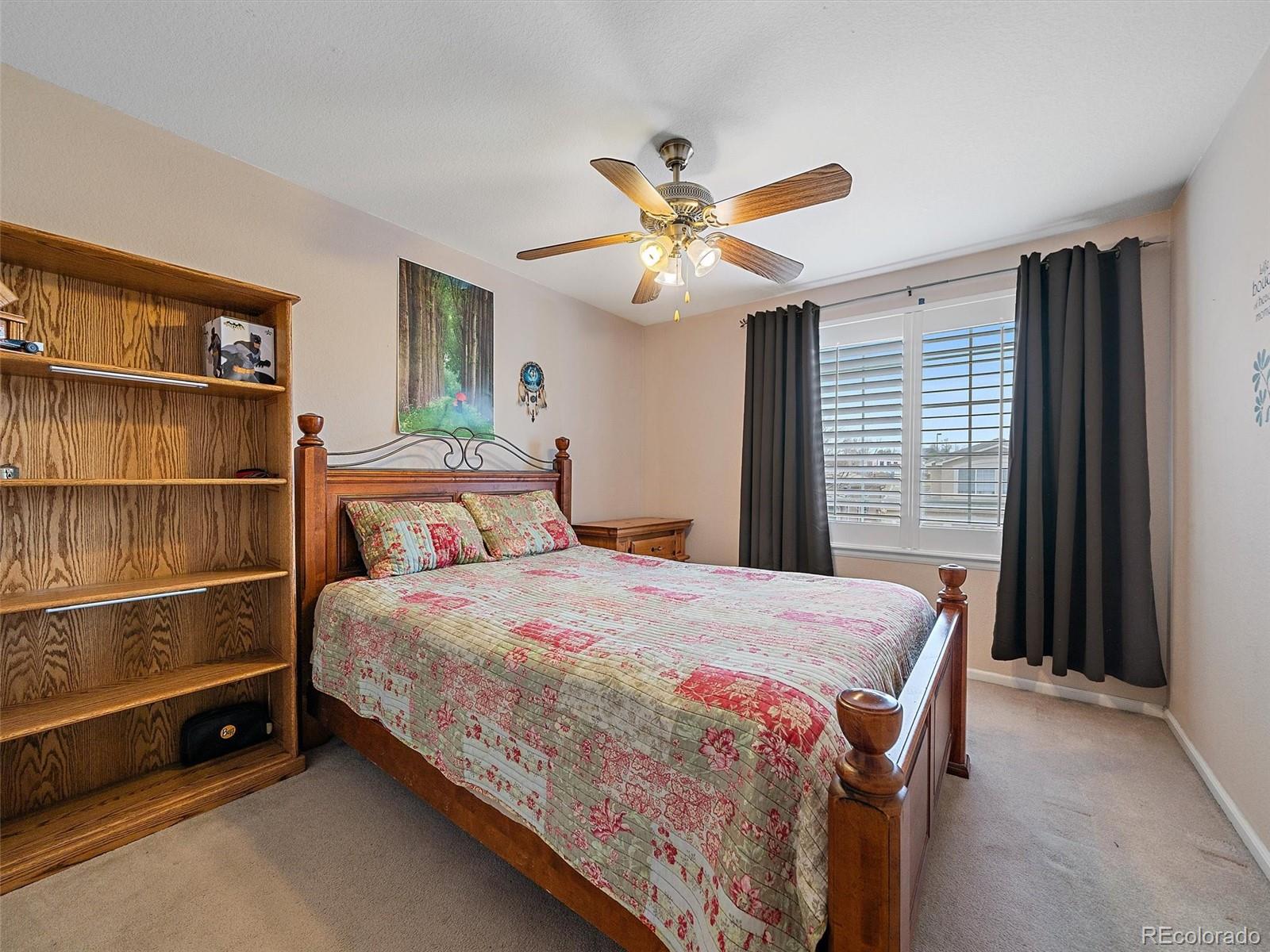 6523 Shannon Trail Highlands Ranch, CO 80130 - Photo 24 of 38 a bedroom with a bed and a chandelier