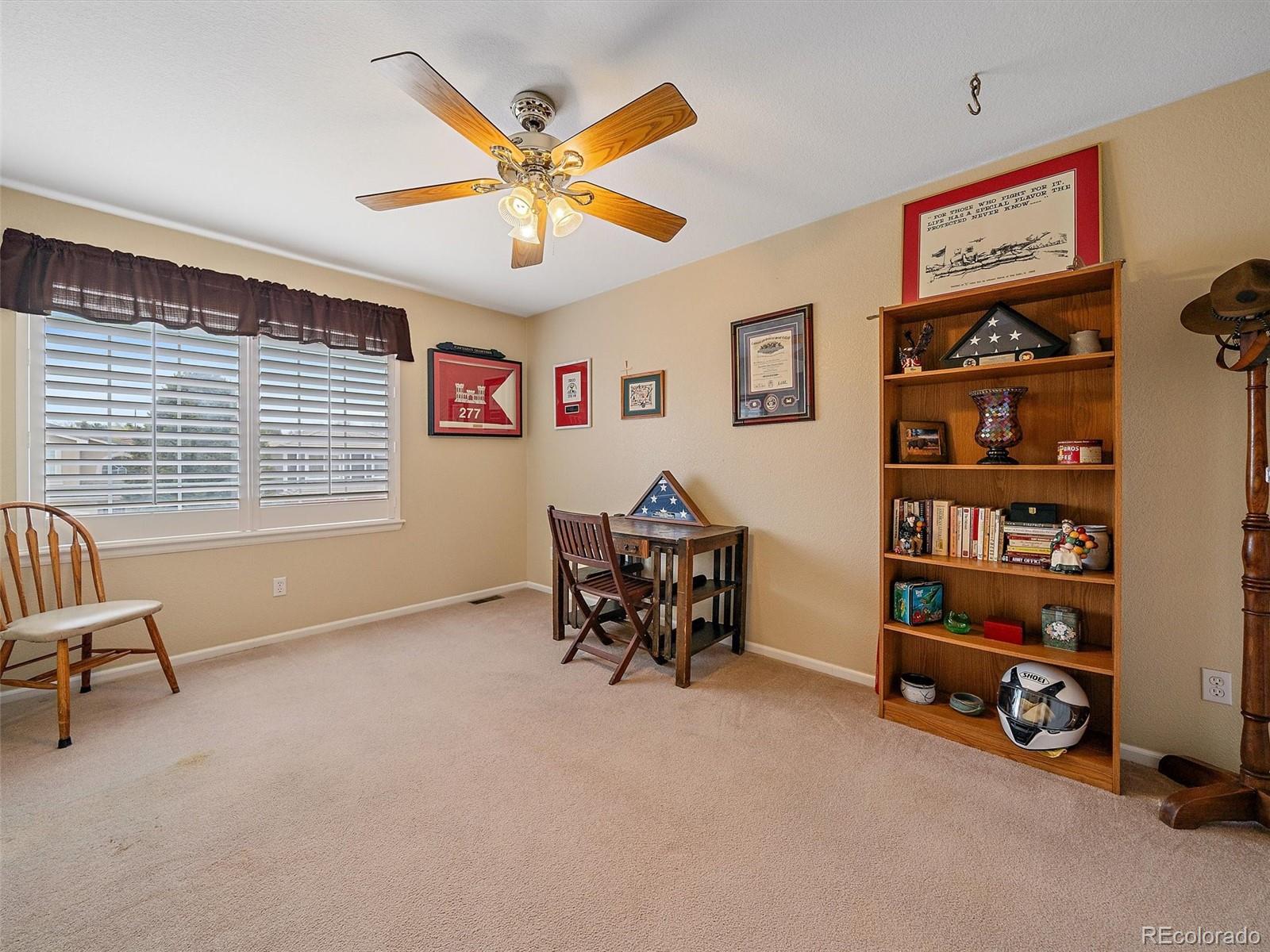 6523 Shannon Trail Highlands Ranch, CO 80130 - Photo 25 of 38 a living room with furniture and a gym machine