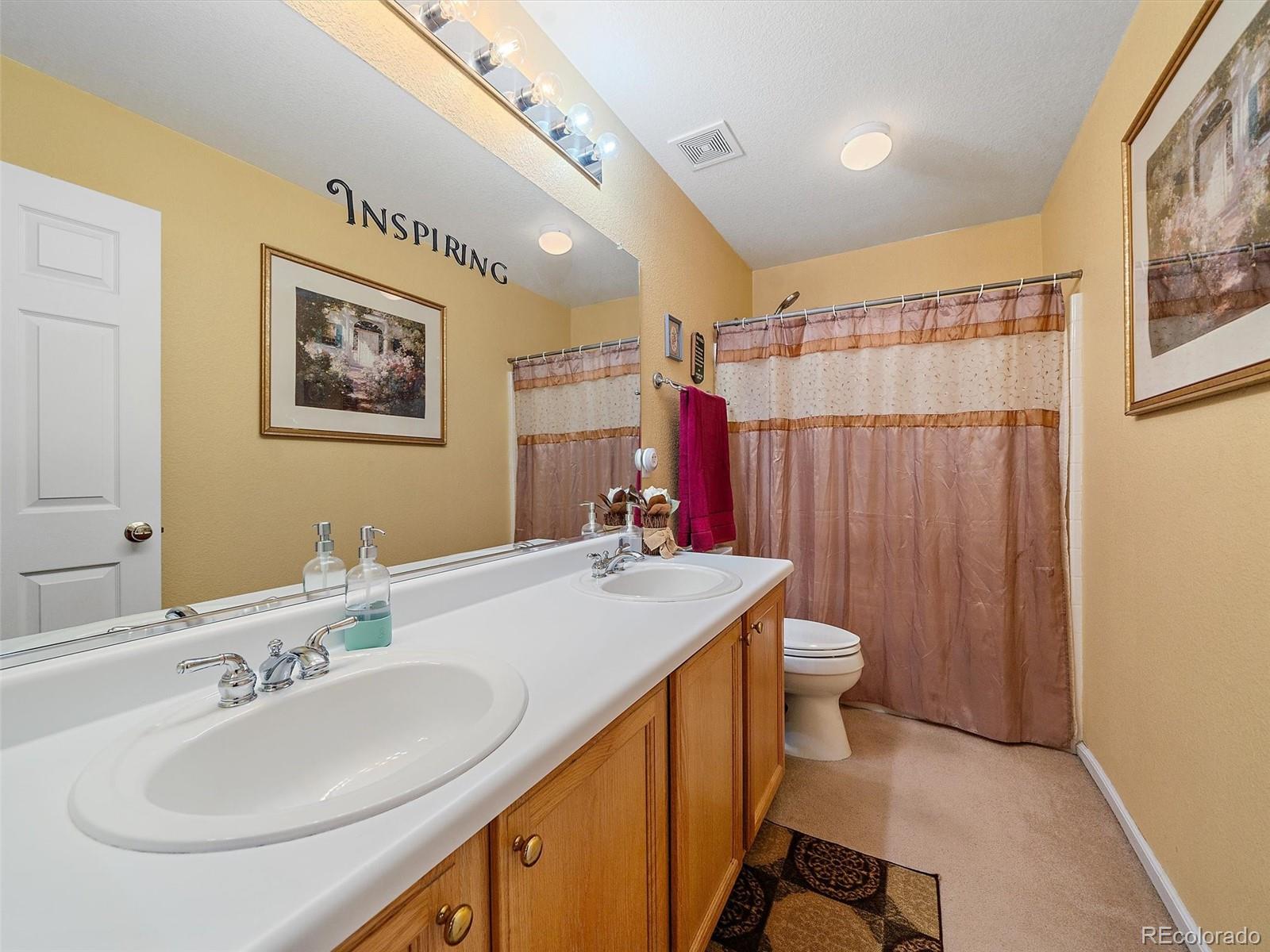 6523 Shannon Trail Highlands Ranch, CO 80130 - Photo 26 of 38 a bathroom with a sink and a mirror