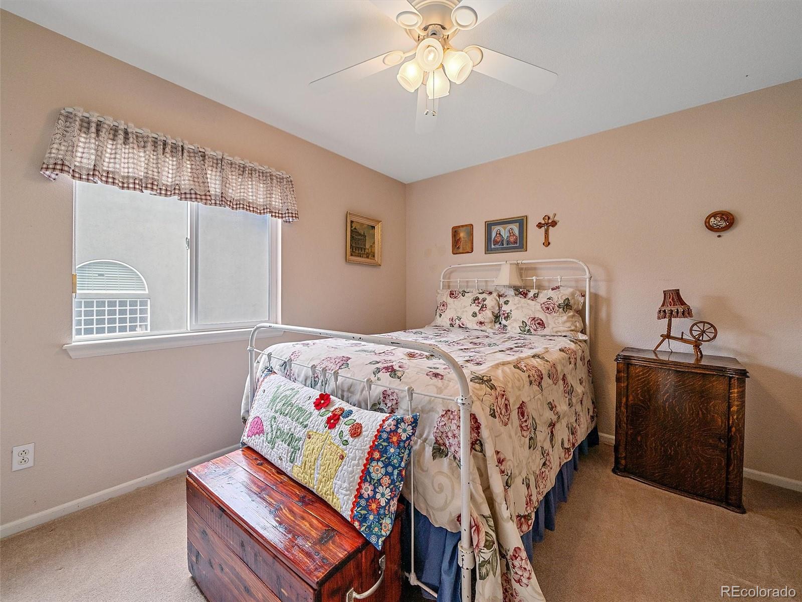 6523 Shannon Trail Highlands Ranch, CO 80130 - Photo 27 of 38 a bedroom with a bed and wooden floor