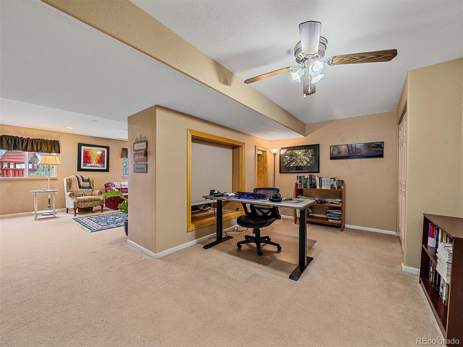 6523 Shannon Trail Highlands Ranch, CO 80130 - Photo 28 of 38 a view of a livingroom with workspace and a window