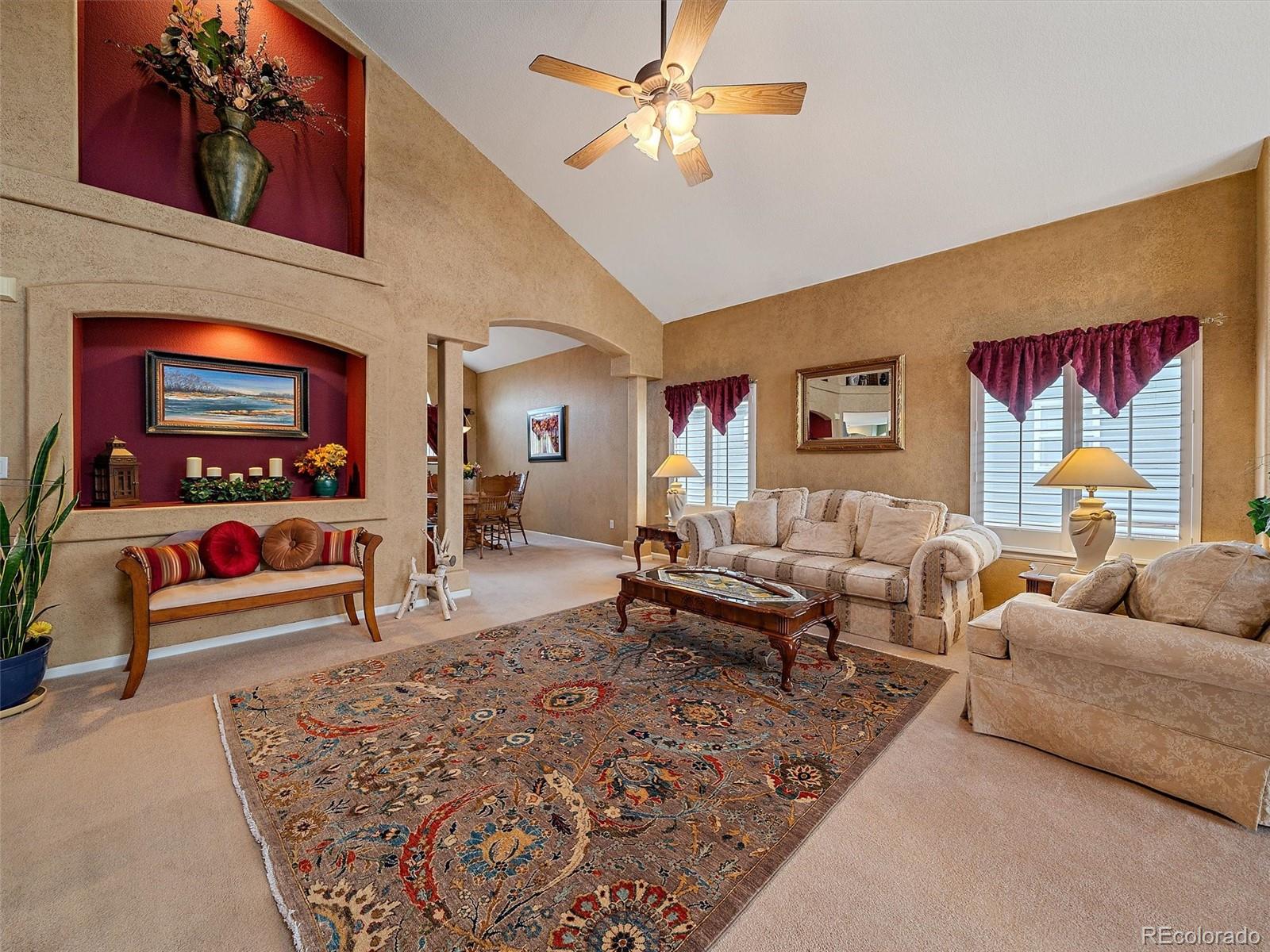 6523 Shannon Trail Highlands Ranch, CO 80130 - Photo 3 of 38 a living room with furniture and a flat screen tv