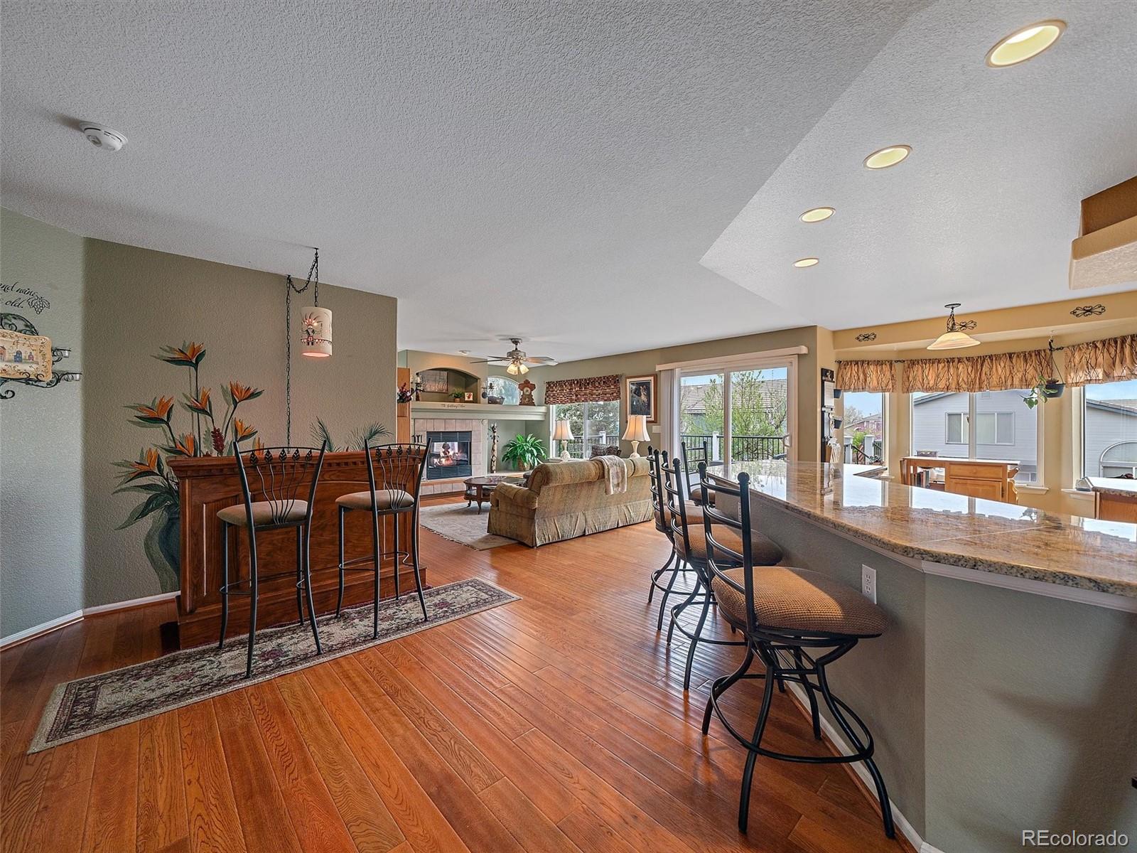 6523 Shannon Trail Highlands Ranch, CO 80130 - Photo 5 of 38 a dining room with furniture a chandelier and wooden floor