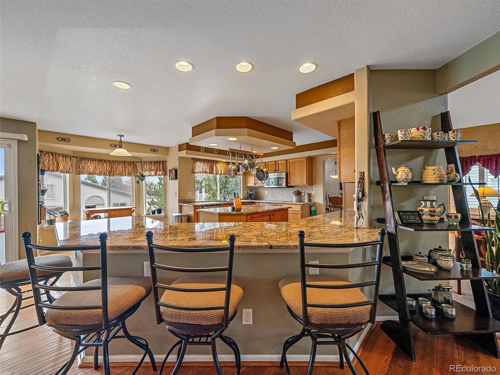 6523 Shannon Trail Highlands Ranch, CO 80130 - Photo 6 of 38 a room with lots of wooden furniture and a table