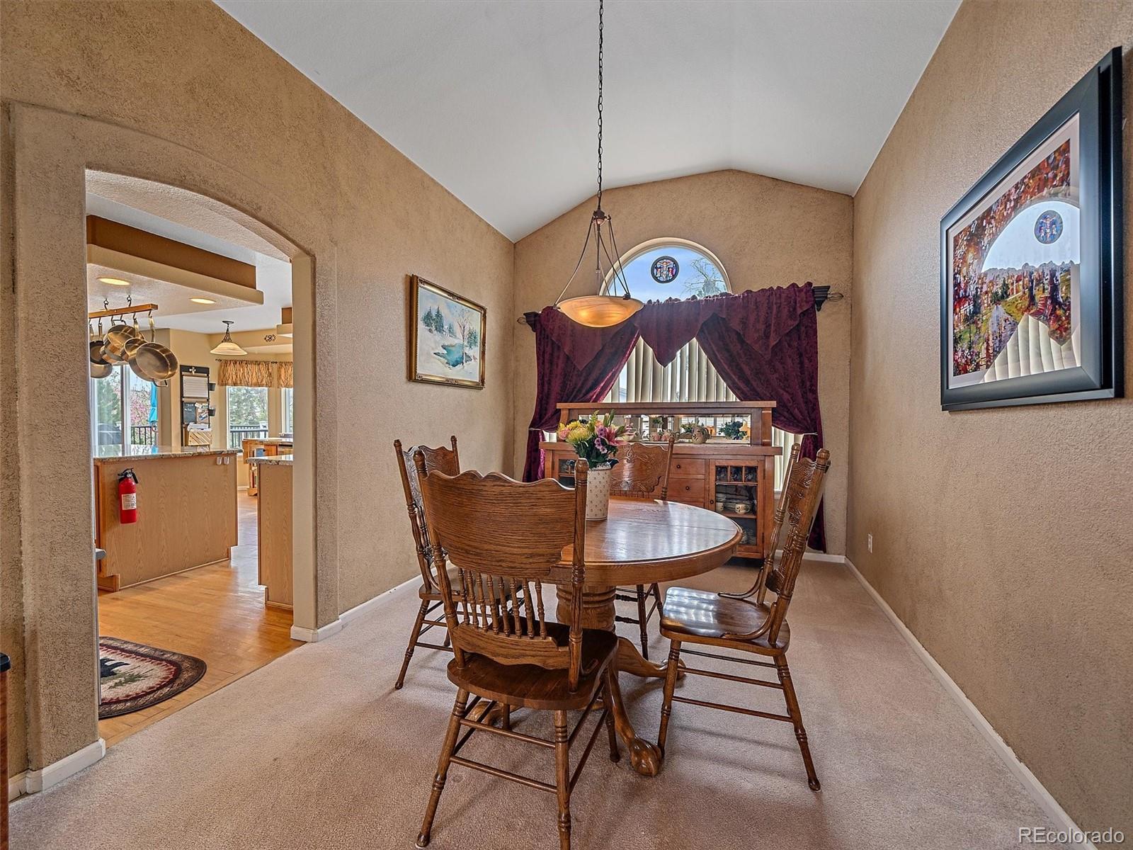 6523 Shannon Trail Highlands Ranch, CO 80130 - Photo 8 of 38 a view of a dining room with furniture and wooden floor