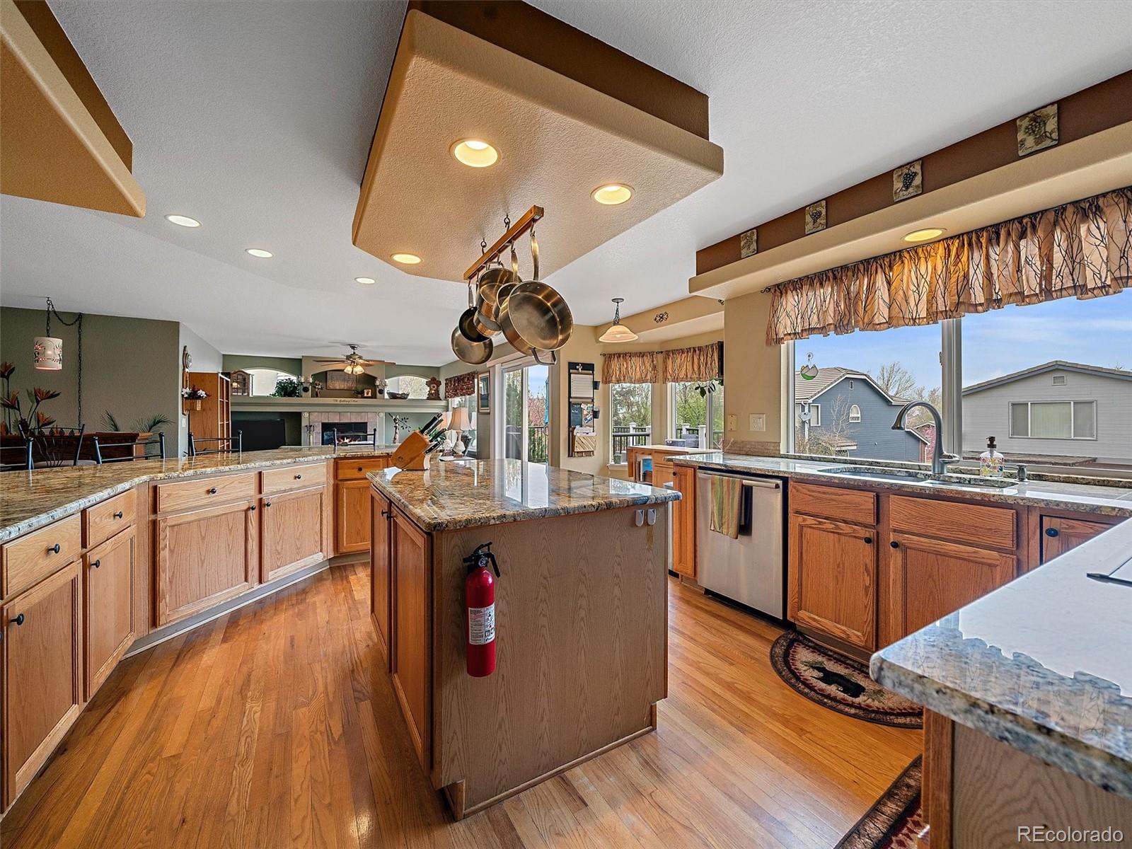 6523 Shannon Trail Highlands Ranch, CO 80130 - Photo 9 of 38 a kitchen with stainless steel appliances granite countertop wooden floors and sink