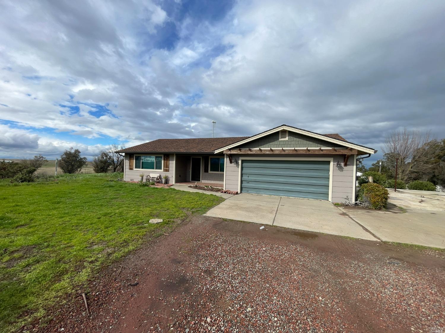 Undisclosed Address Rio Vista, CA 94571 - Photo 1 of 1 a front view of a house with a yard and garage