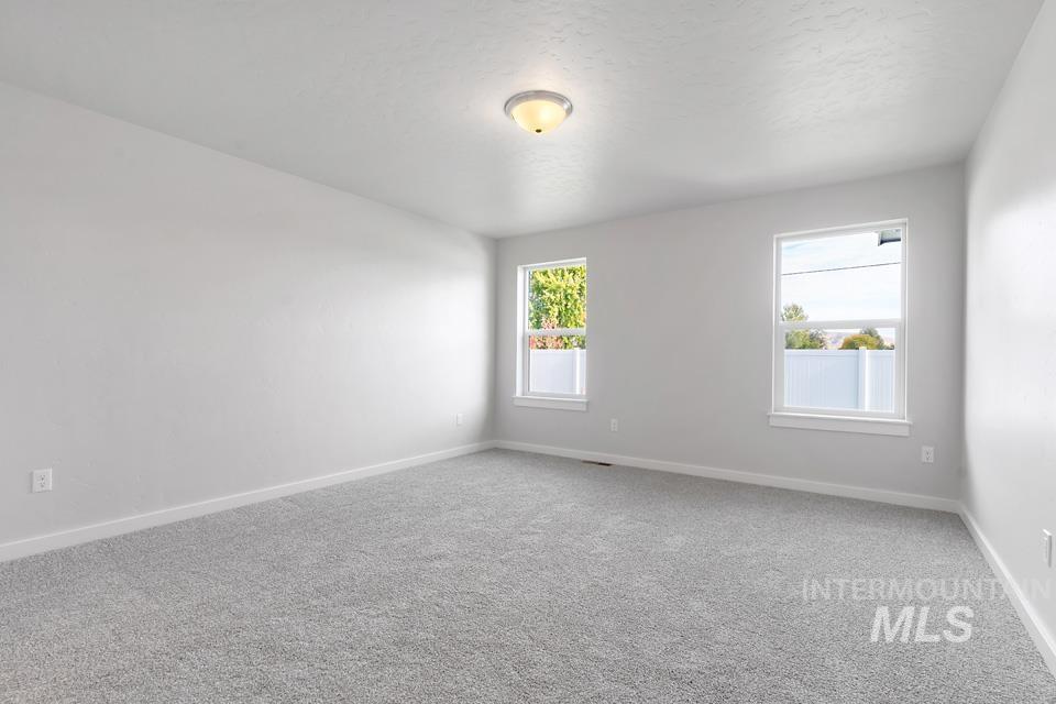 1340 Dawn Street Weiser, ID 83672 - Photo 13 of 32 Carpeted spare room with healthy amount of natural light