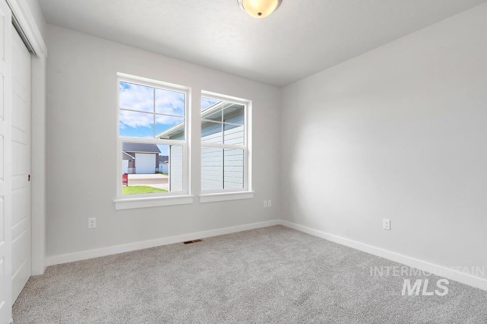 1340 Dawn Street Weiser, ID 83672 - Photo 21 of 32 Empty room with light carpet and baseboards