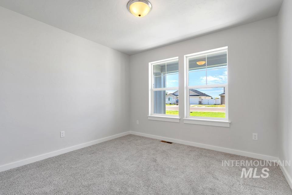 1340 Dawn Street Weiser, ID 83672 - Photo 23 of 32 Spare room with light carpet and baseboards