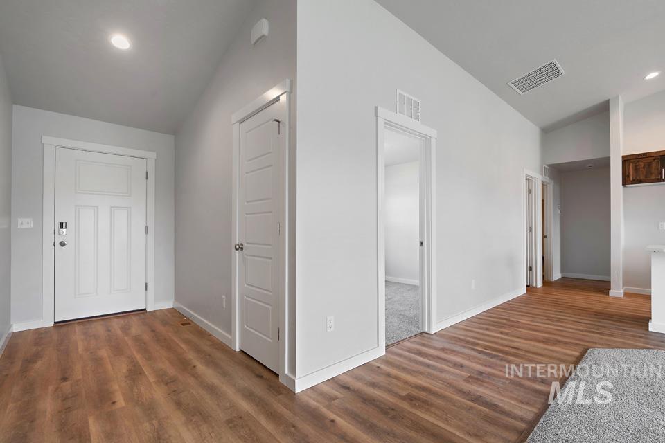 1340 Dawn Street Weiser, ID 83672 - Photo 5 of 32 Hallway with lofted ceiling, recessed lighting, and dark wood-style floors