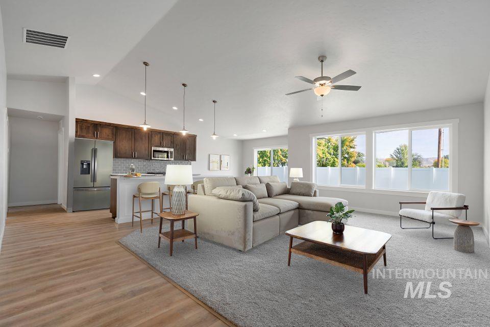 1340 Dawn Street Weiser, ID 83672 - Photo 6 of 32 Living room featuring lofted ceiling, light wood finished floors, and a ceiling fan