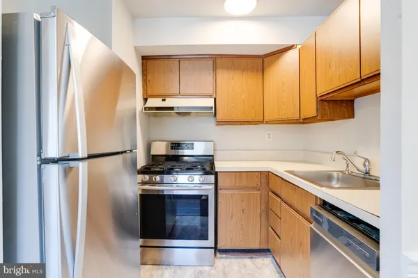 a kitchen with a refrigerator sink and stove