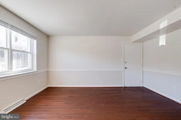 wooden floor in an empty room with a window