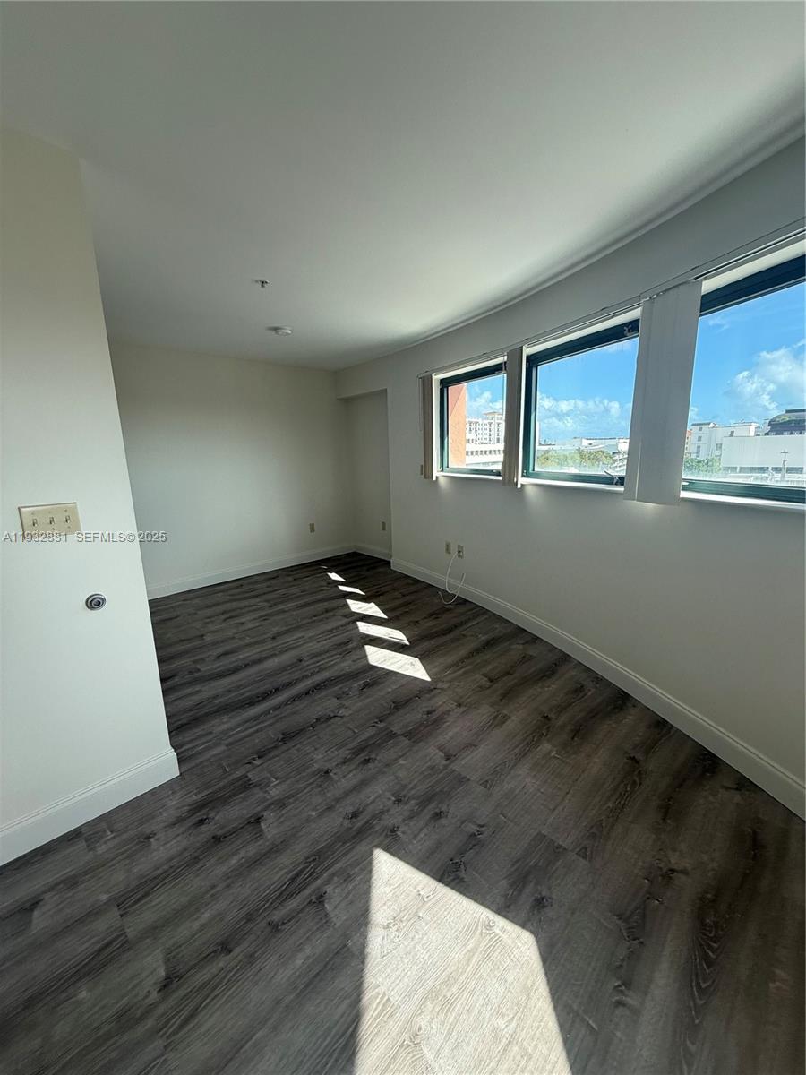 5725 Southwest 72nd Street, Unit 5725 Miami, FL 33143 - Photo 3 of 5 wooden floor in an empty room