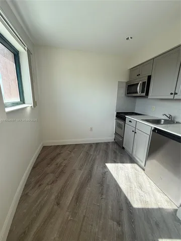 a kitchen with a stove and a refrigerator