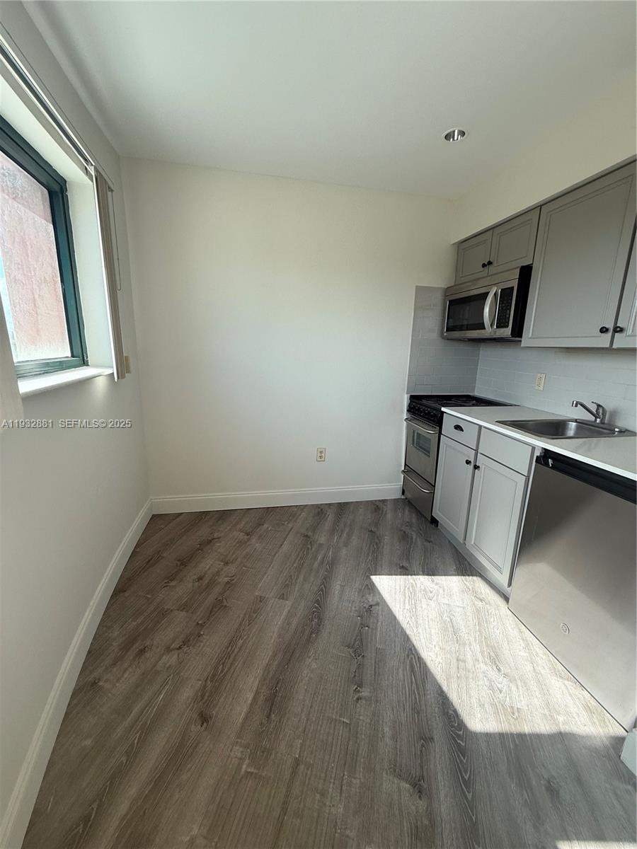 5725 Southwest 72nd Street, Unit 5725 Miami, FL 33143 - Photo 5 of 5 a kitchen with a stove and a refrigerator