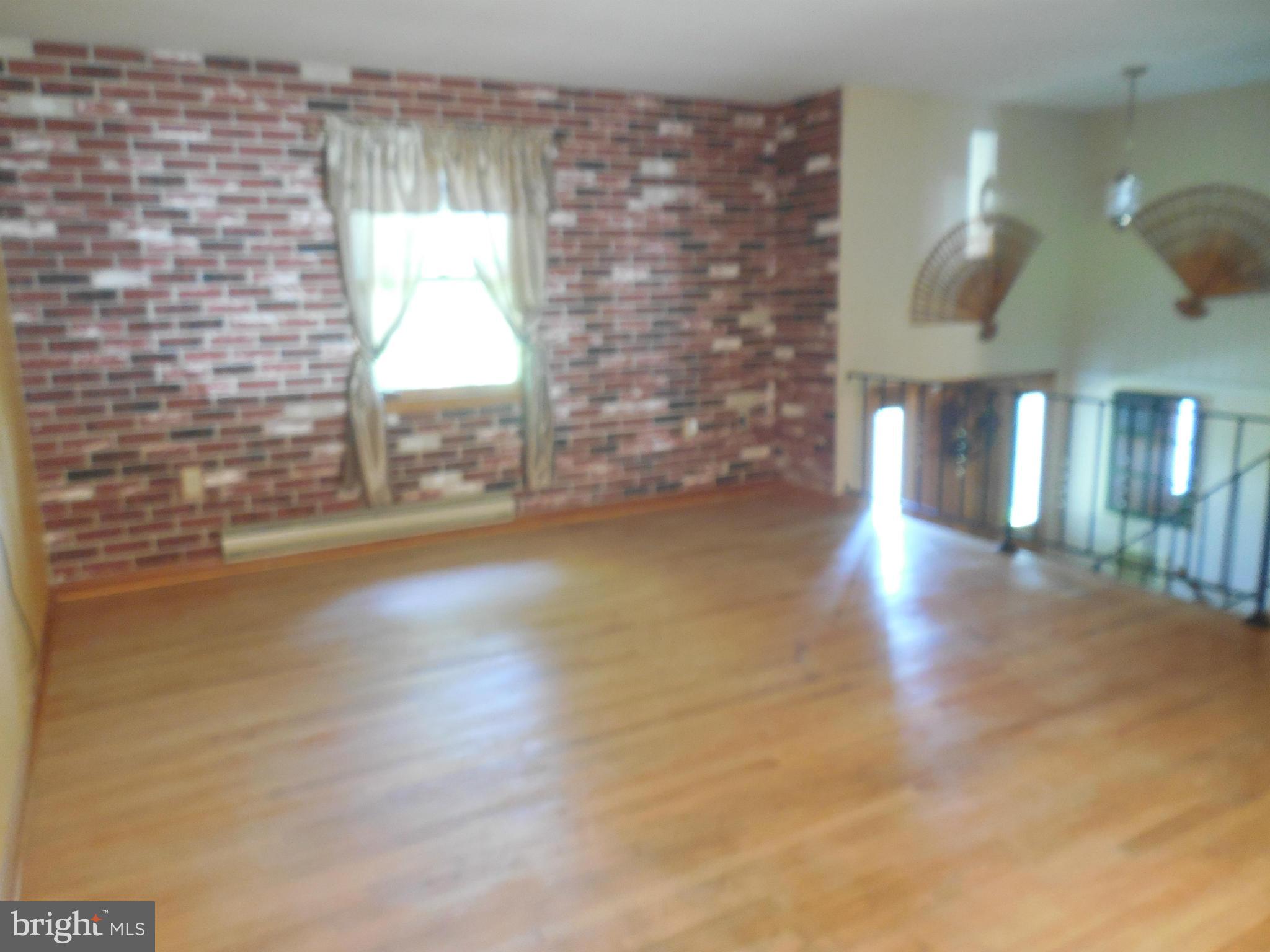 15057 New Windsor Road New Windsor, MD 21776 - Photo 3 of 30 Living Room has a zbrick wall