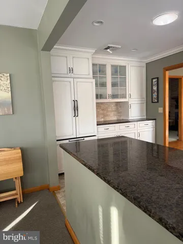 a view of a kitchen with furniture and a window