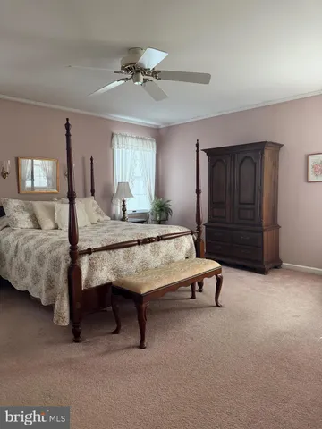 a bedroom with a bed and ceiling fan