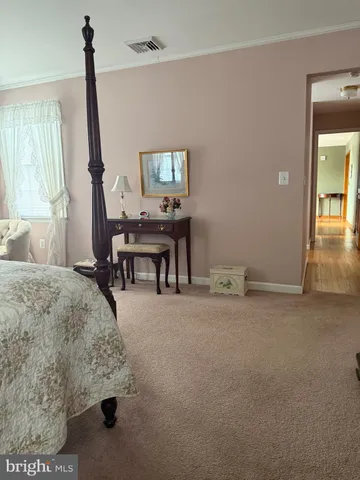 a view of a workspace with furniture and window