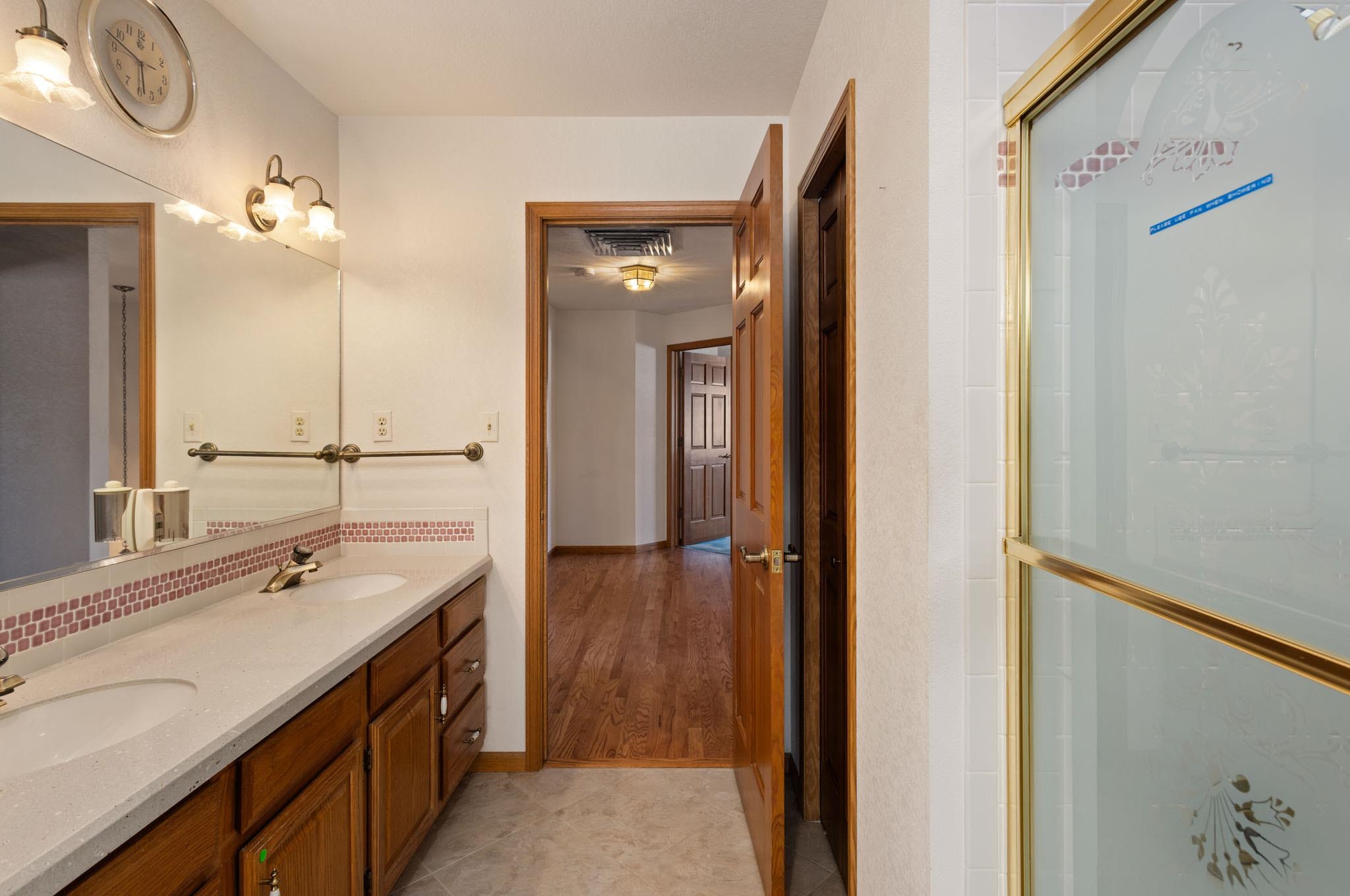 1331 Ruby Way Longmont, CO 80504 - Photo 12 of 42 a bathroom with a double vanity sink and a mirror
