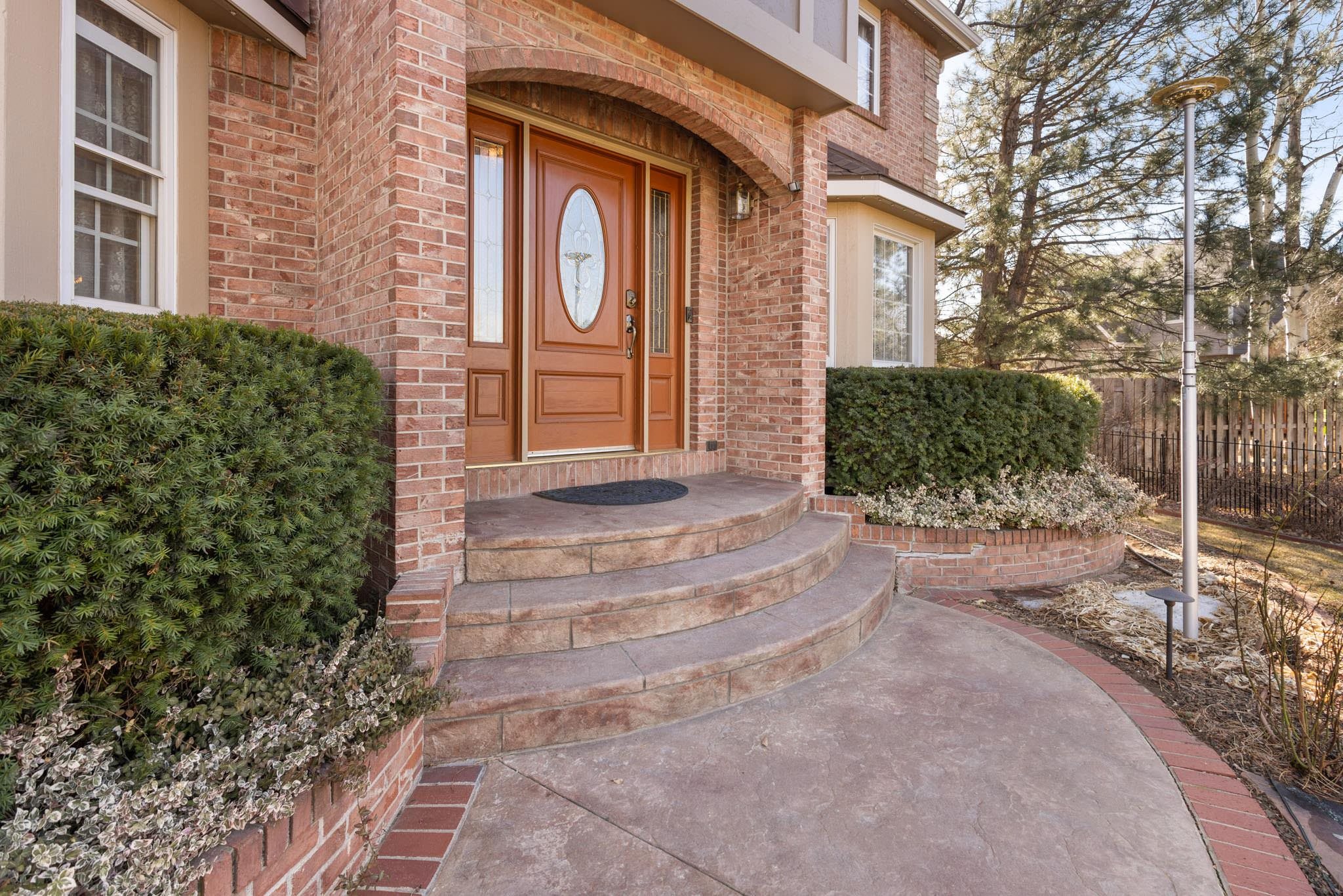 1331 Ruby Way Longmont, CO 80504 - Photo 40 of 42 a couple of potted plants in front of a brick building