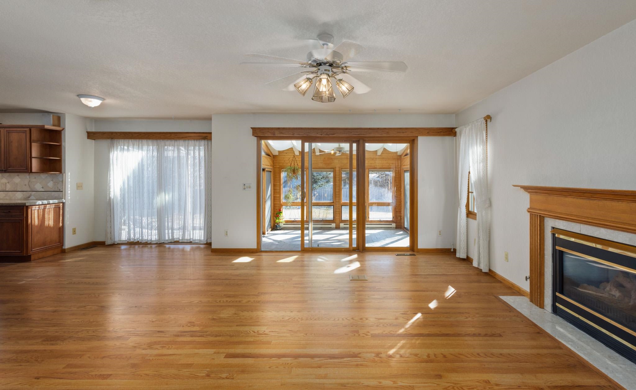1331 Ruby Way Longmont, CO 80504 - Photo 8 of 42 a view of an empty room with a fireplace and a window