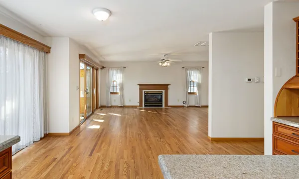 a view of a hallway with wooden floor and entryway