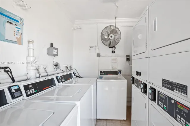 a view of a kitchen with a stove top oven a clock and a clock