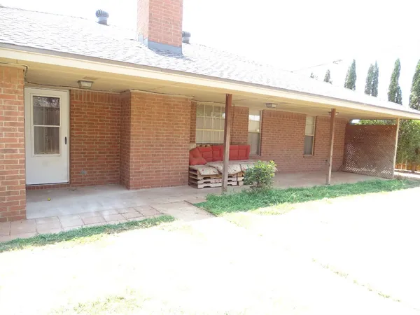 a front view of a building with potted plants