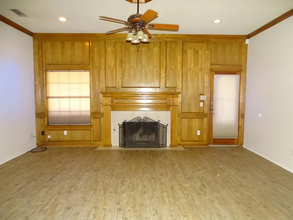 a view of empty room with a fireplace