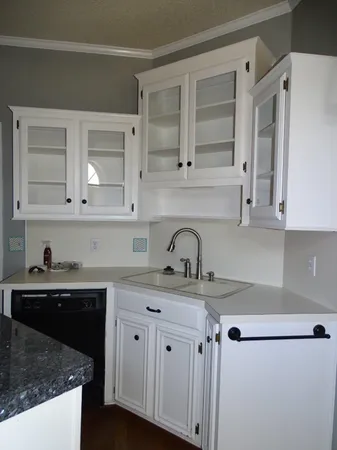 a kitchen with a sink dishwasher and cabinets