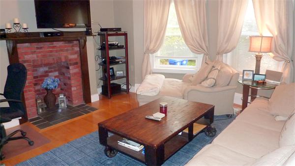 14 Linden Street, Unit 2 Brookline, MA 02445 - Photo 2 of 16 a living room with furniture a flat screen tv and a large window